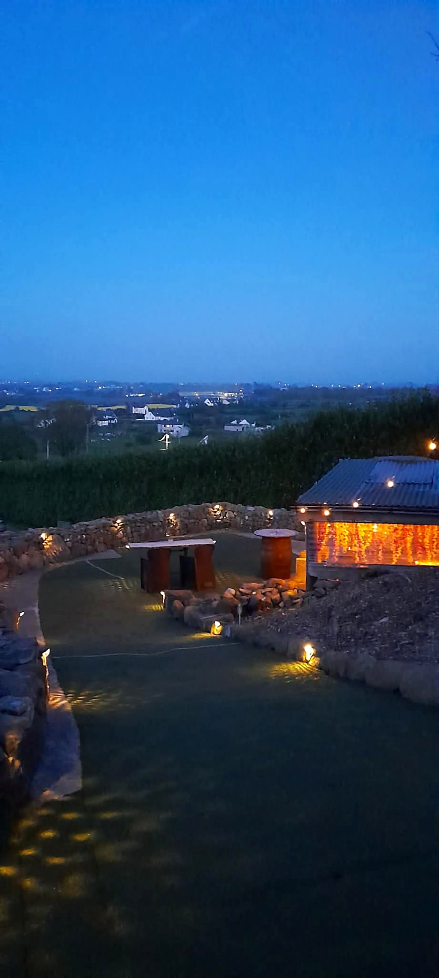 Blue hour over Fairy Cove with the cooking shelter lit and the valley beyond
